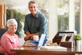 Adult Son Helping Mother With Laptop Royalty Free Stock Photo