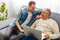 Adult Son Helping Senior Father With Computer At Home Royalty Free Stock Photo