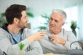 adult son helping senior father at home Royalty Free Stock Photo