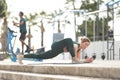 Adult sportive woman doing stretching exercises on yoga mat