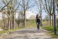 Adult sportive woman jogging in the autumn park