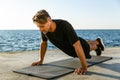 adult sportsman with wireless earphones doing push ups Royalty Free Stock Photo