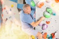 Adult man practicing rock climbing on climbing wall Royalty Free Stock Photo