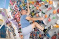 Adult man practicing rock climbing on climbing wall Royalty Free Stock Photo
