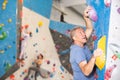 Adult man practicing rock climbing on climbing wall Royalty Free Stock Photo