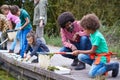 Adult Team Leaders Show Group Of Children On Outdoor Activity Camp How To Catch And Study Pond Life Royalty Free Stock Photo