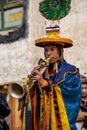 Adult Tibetan Buddhist worshiper with a ritual horn at Tiji Festival in ancient Lo Manthang