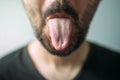 Adult unshaven man sticking tongue out Royalty Free Stock Photo