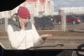 Upset young woman after a car accident calling on the phone Royalty Free Stock Photo