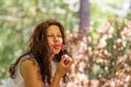 Adult woman blowing soap bubbles Royalty Free Stock Photo