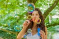 Adult woman blowing soap bubbles Royalty Free Stock Photo