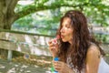 Adult woman blowing soap bubbles Royalty Free Stock Photo