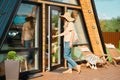 Adult woman brings fresh vegetables in string bag from the market to her wooden cabin