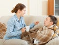 Adult woman caring for sick man