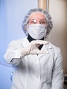 Adult woman closeup protective glasses and medical mask holding in his hand glass syringe Royalty Free Stock Photo