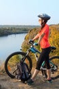 Adult woman cyclist admiring the landscape. Royalty Free Stock Photo