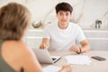 Adult woman discussing deal with salesman in kitchen