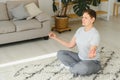 Adult woman doing fitness exercises at home. Senior woman do stretching exercises. Mature woman doing yoga poses