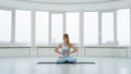 Adult woman doing Pranayama breathing exercise in Lotus pose