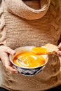 Adult woman eating pumpkin soup in the kitchen Royalty Free Stock Photo