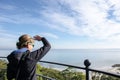 Adult woman enjoys the view after climbing the top of Hunting Island Lighthouse Royalty Free Stock Photo