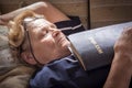 Adult woman fell asleep with a bible in her hands Royalty Free Stock Photo