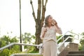 Adult woman with handbag drinking coffee in park Royalty Free Stock Photo