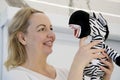 an adult woman in her hands with a soft striped toy false jaw at a zebra a woman shows tongue smiling dentistry dental Royalty Free Stock Photo