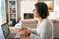 Adult  woman having video chat online on laptop with her granddaughter at home Royalty Free Stock Photo