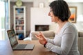 Adult  woman having video chat online on laptop with her granddaughter at home during quarantine isolation Royalty Free Stock Photo