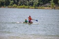 Adult woman and her child paddleboarding together in Hyrum, USA