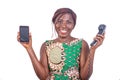 Adult woman holding a telephone handset and a smartphone smiling Royalty Free Stock Photo