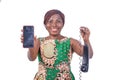 Adult woman holding a telephone handset and a smartphone smiling Royalty Free Stock Photo