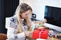 Adult woman at home wrapping Christmas presents Royalty Free Stock Photo