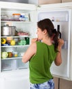 Adult woman looking for eat in refrigerator Royalty Free Stock Photo