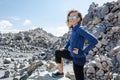 Adult woman poses on rocks at the Obsidian Dome trail in California`s eastern sierra, near Mammoth Lakes Royalty Free Stock Photo