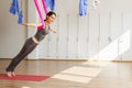 Adult woman practices aero anti-gravity yoga position in studio Royalty Free Stock Photo