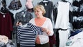 Adult woman purchaser choosing striped dress