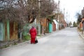 an adult woman in red clothes was lost in a small town Royalty Free Stock Photo