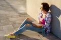 Adult woman relaxing sit on the sidewalk. Royalty Free Stock Photo