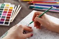 Adult woman relieving stress by painting coloring book for relax