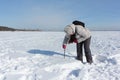 Woman sawing a snowy block for building an igloo