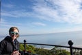 Adult woman smiles and enjoys the view after climbing the top of Hunting Island Lighthouse Royalty Free Stock Photo