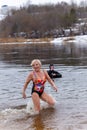 An adult woman splashes in the river in winter Royalty Free Stock Photo