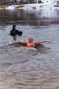 An adult woman splashes in the river in winter Royalty Free Stock Photo