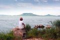 Adult woman stays on Lake Balaton in summer