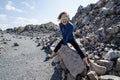 Adult woman straddles on rocks at the Obsidian Dome trail in California`s eastern sierra, near Mammoth Lakes Royalty Free Stock Photo