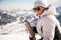 Adult woman with thermos on mount top with spectacular view of snowy mountains on background Royalty Free Stock Photo