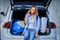 Adult woman tourist in underground airport parking lot