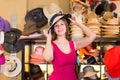 Adult woman try on hatinator hat in shopping mall Royalty Free Stock Photo